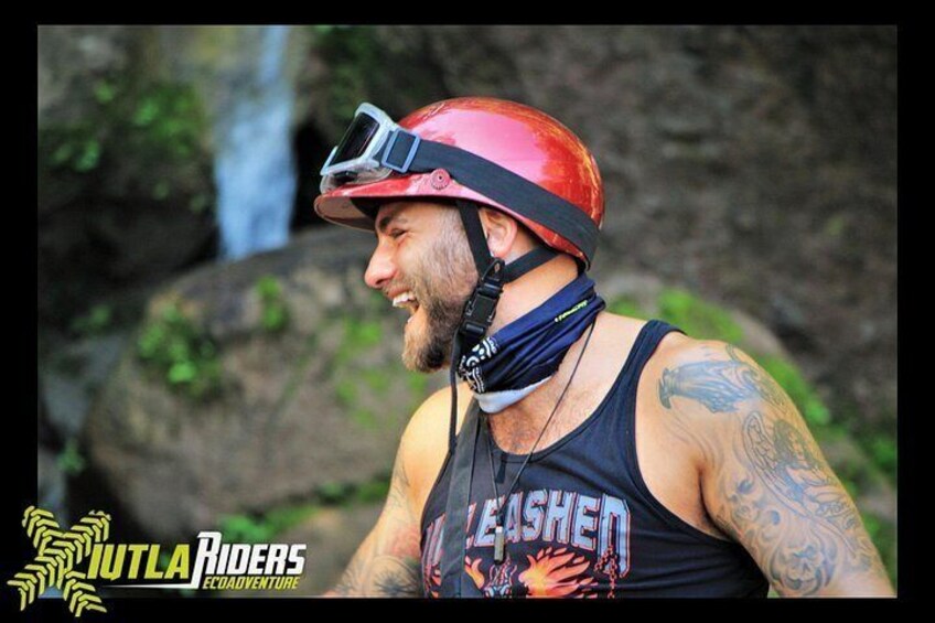 A person wearing a helmet and a tank top with a tattoo on their arm. 3