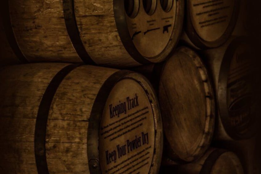 Wooden barrels stacked closely together. 2