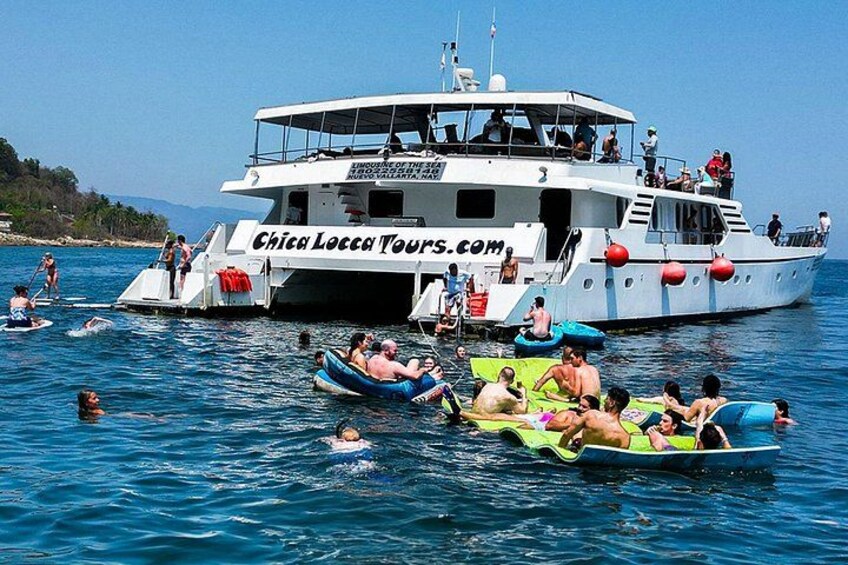 Een boot met mensen op luchtbedden in het water. 5
