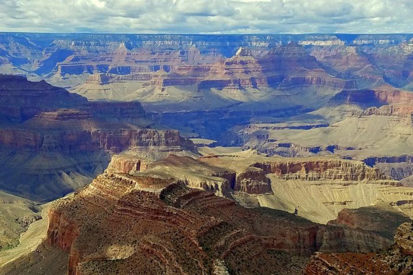 Weite Canyon-Landschaft mit schichtartigen Felsformationen und einer Fernsicht zum Horizont. 1