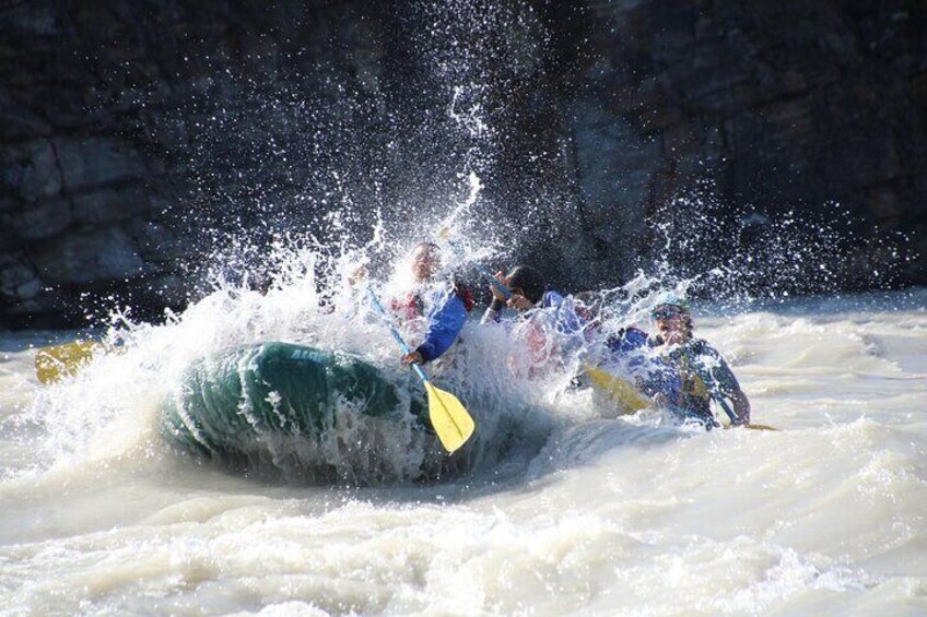 A white water rafting scene with people in kayaks navigating through rapids. 4
