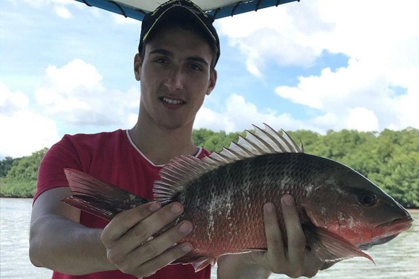 A person holding a fish. 2