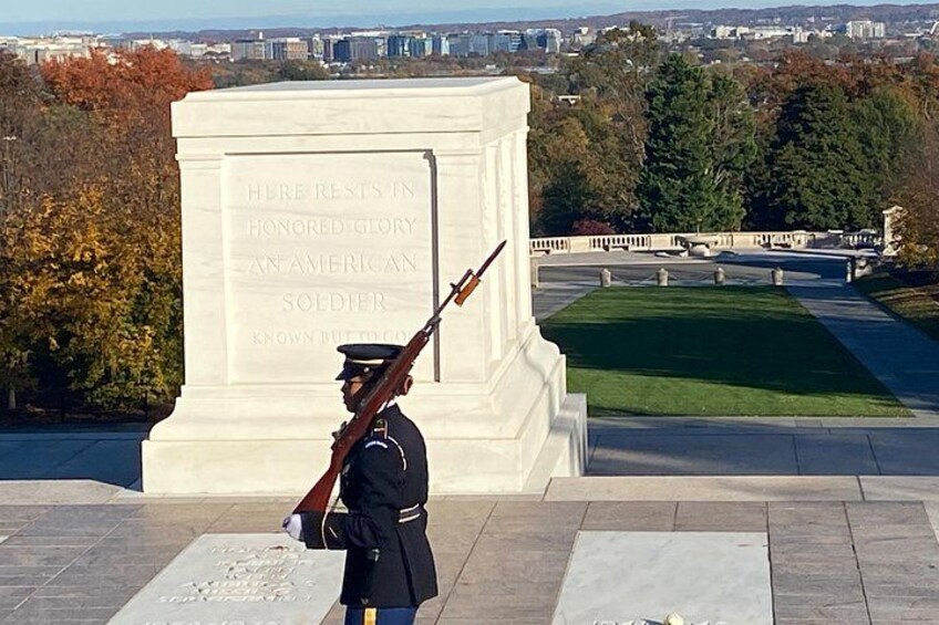 A memorial with a soldier in uniform standing guard. 2