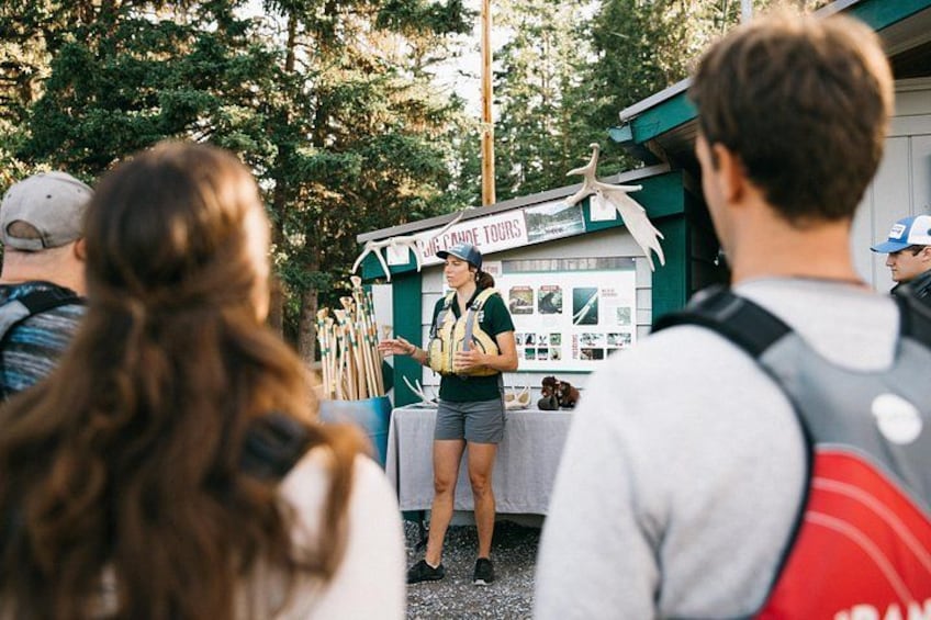 A person standing at a booth with a sign that reads 'JULIE CATE TOUR'. 2