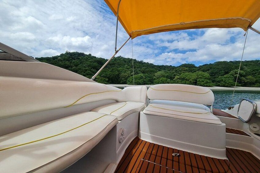 A boat's interior with cushioned seating and a wooden deck. 4