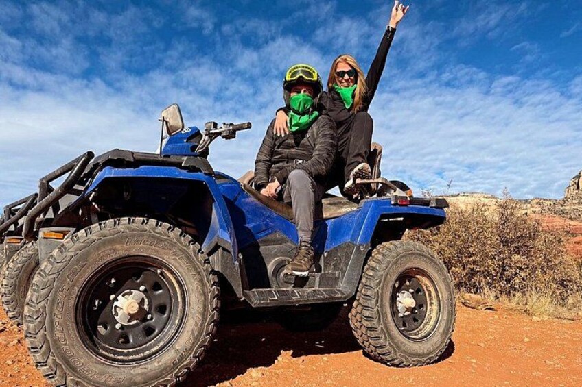 Twee personen op een blauwe quad in een woestijnlandschap. 3