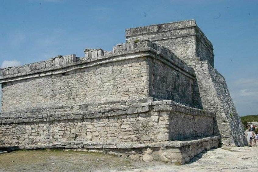 A large stone structure with a flat top and a stepped base, likely a historical building or monument. 5
