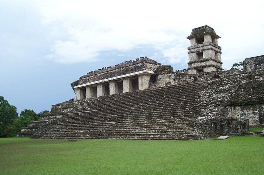 Ancient ruins with a large stepped pyramid and a tower-like structure. 4