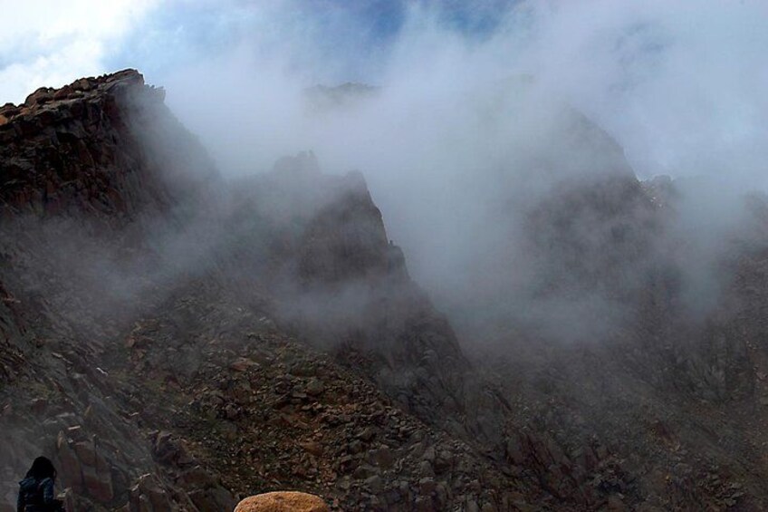 A rocky mountain landscape with mist and clouds. 2