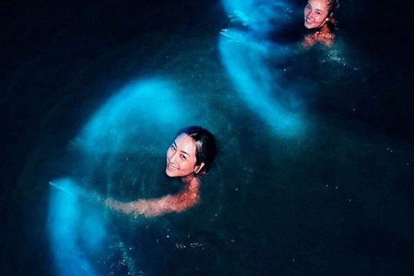 Dos personas nadando en una piscina con efectos de luz azul. 2
