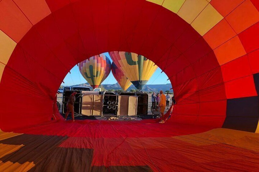 A hot air balloon in a large, colorful, semi-circular structure. 4