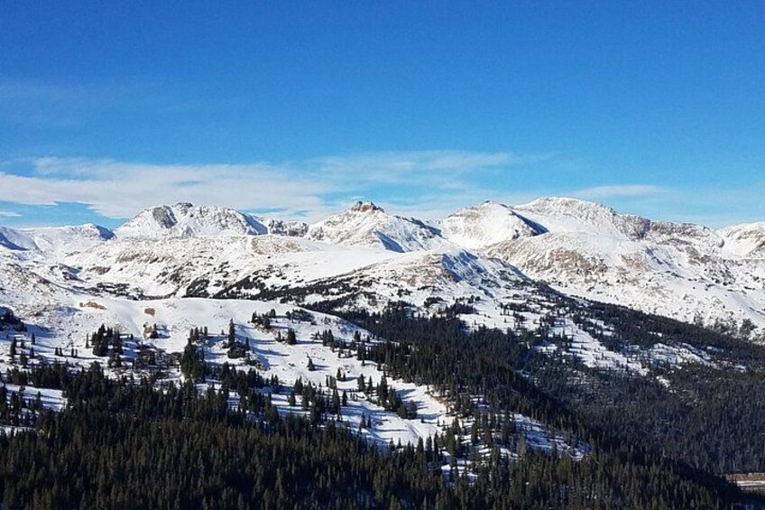 A snow-covered mountain range with a ski resort in the foreground. 1