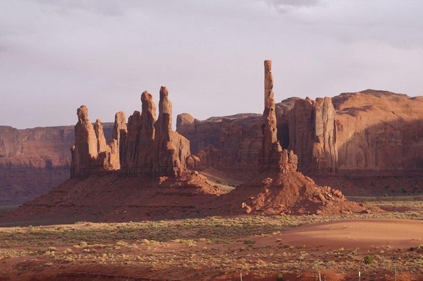 A desert landscape with prominent rock formations and a clear sky. 3