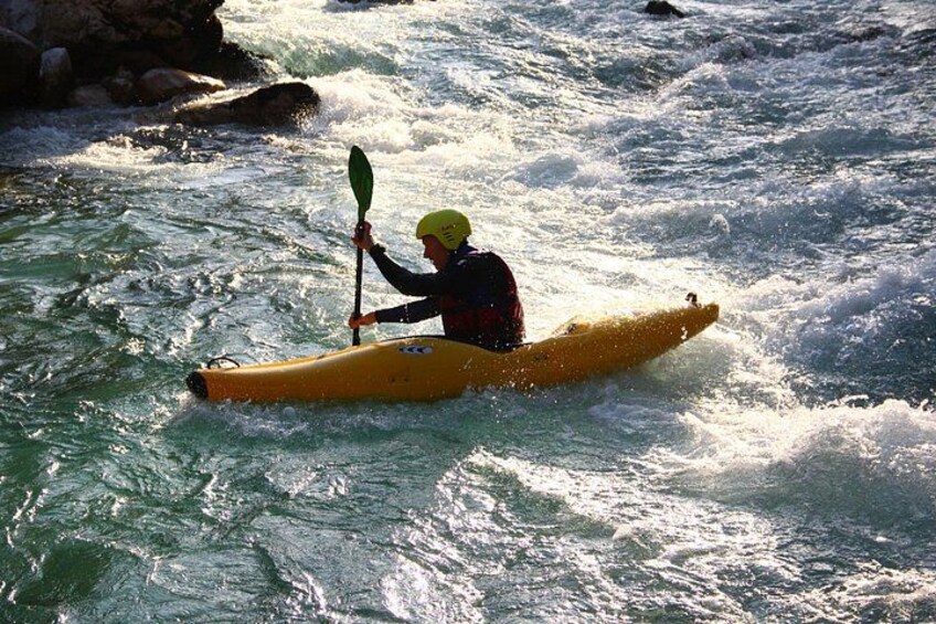 A person kayaking on a river. 4