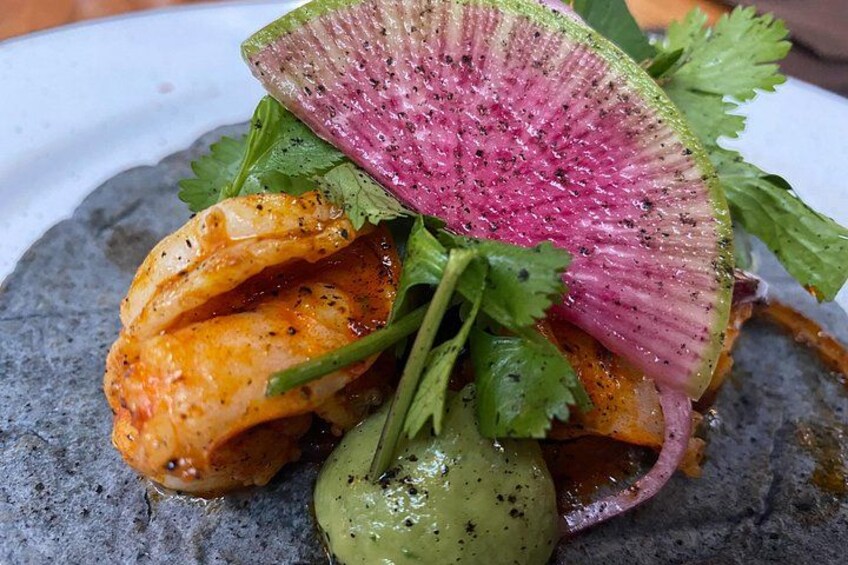 Un plato con camarones, una rodaja de rábanos y cilantro. 2