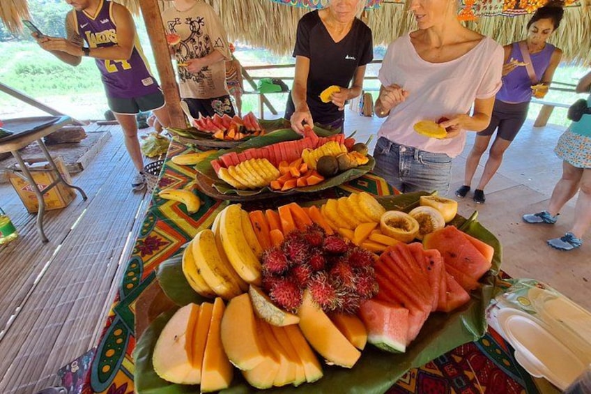 A fruit display with various tropical fruits on a table. 2