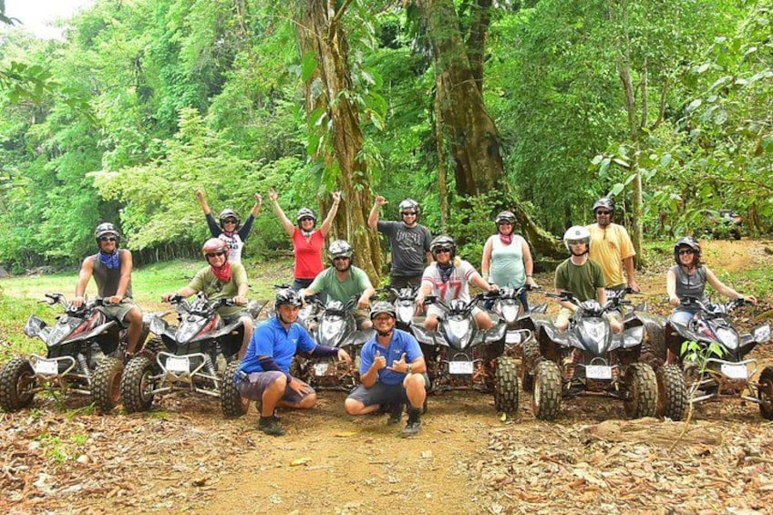 A group of people on ATVs in a forested area. 5