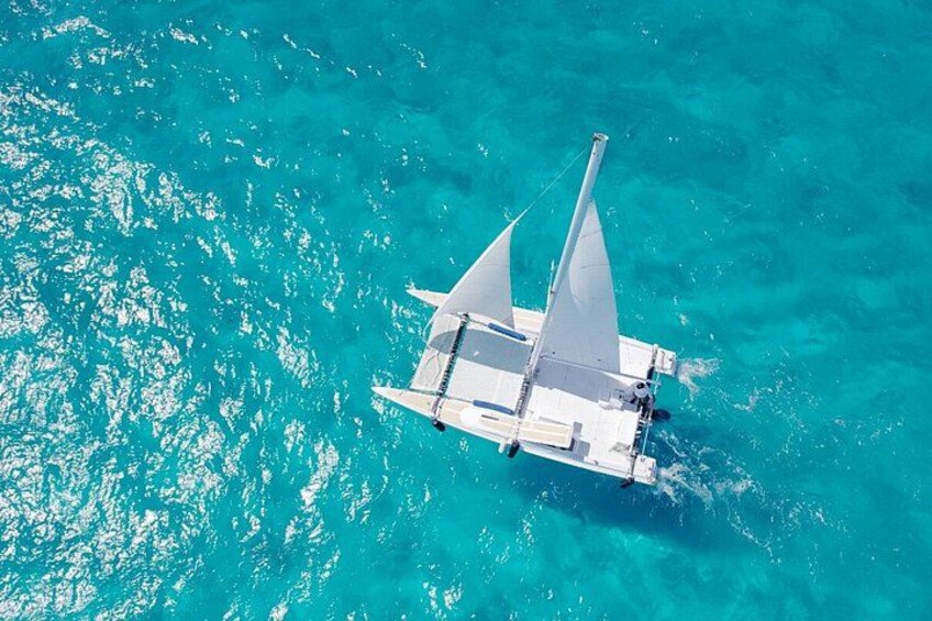 A sailboat on turquoise water. 2