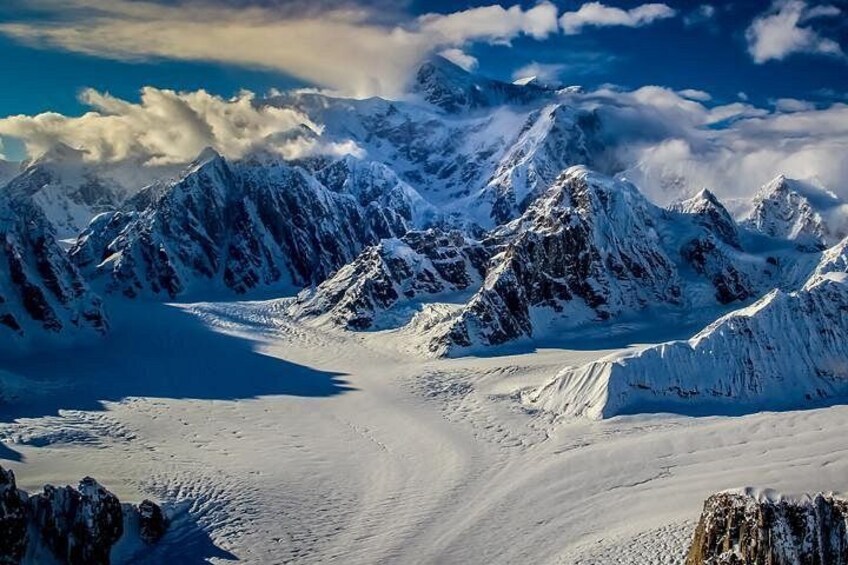 A snow-covered mountain range with a glacier. 5
