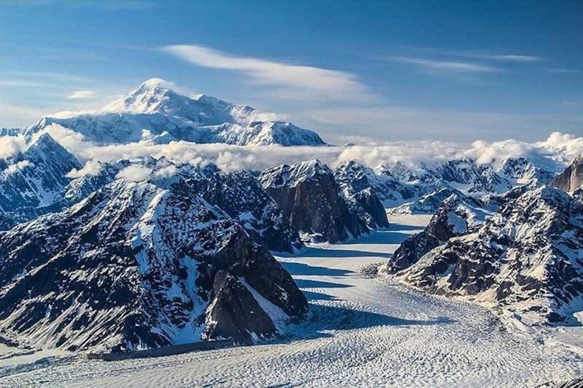 A snow-covered mountain range with sharp peaks and a glacier. 5