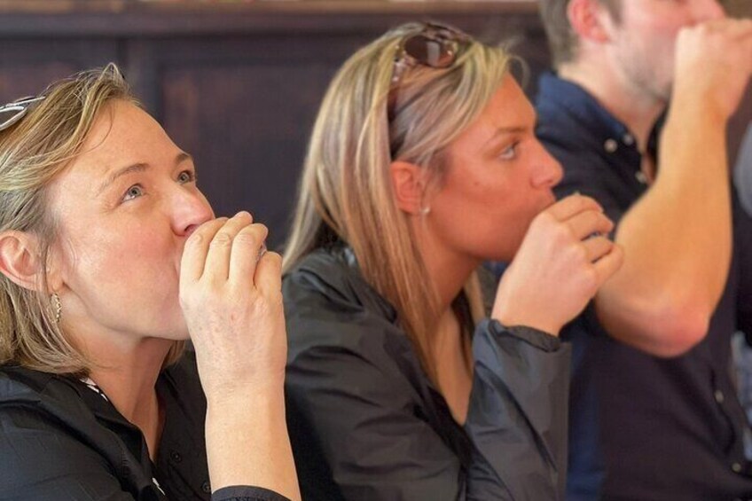 A group of people sitting closely together, possibly in a meeting or event. 2