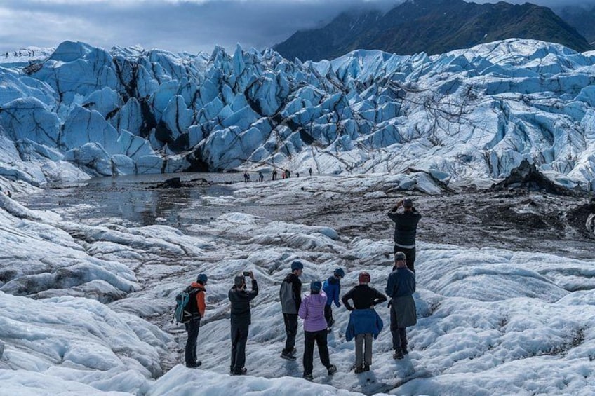 A glacier with people observing. 2
