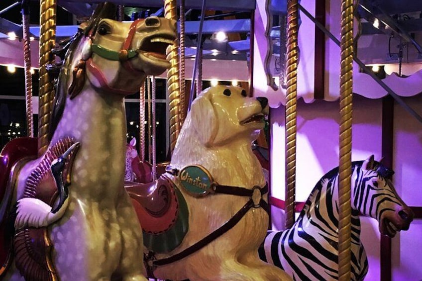 Ein Karussell mit einem Pferd, einem Hund und einem Zebra. 3