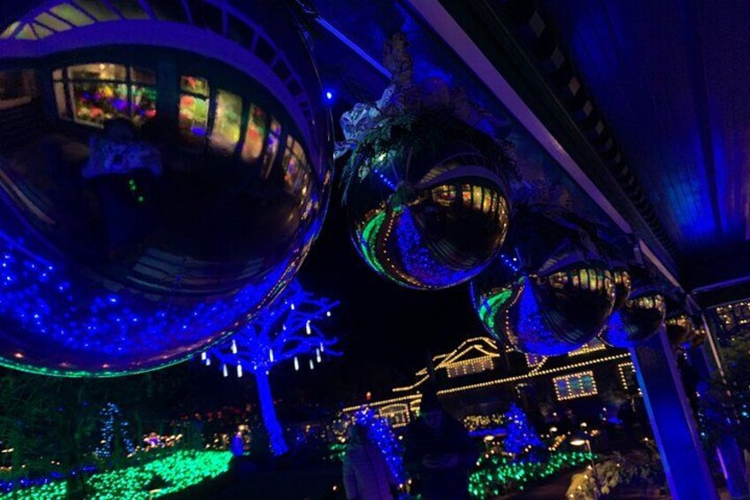 A building with large spherical structures and illuminated windows. 3