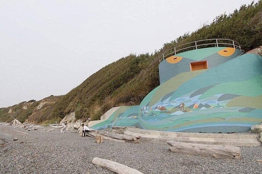 A large, colorful mural on a hillside. 3