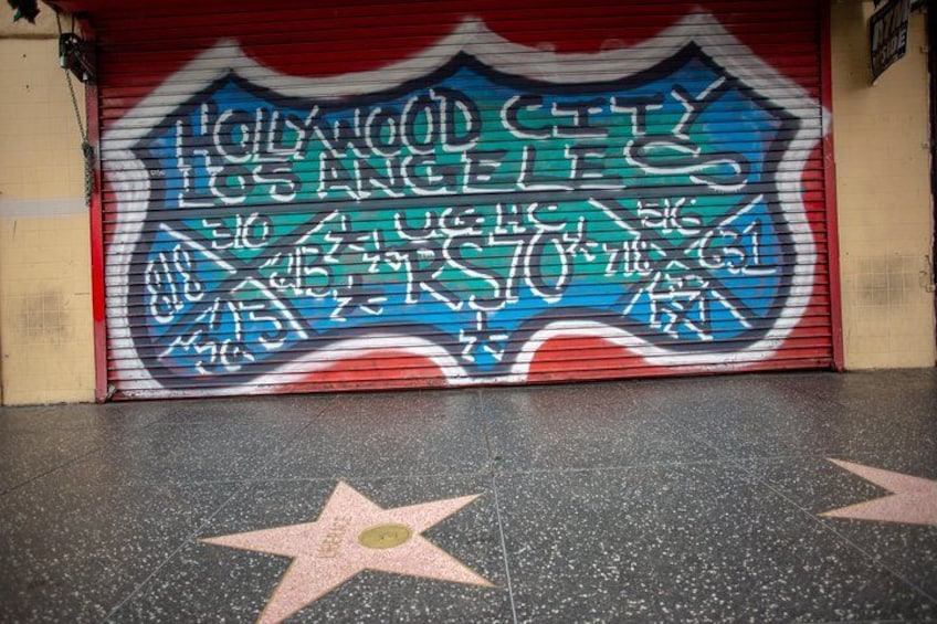 Street art frames a part of the Hollywood Walk of Fame which includes over 2,600 five-pointed stars and publicly celebrates the achievements of America’s entertainment industry. 3