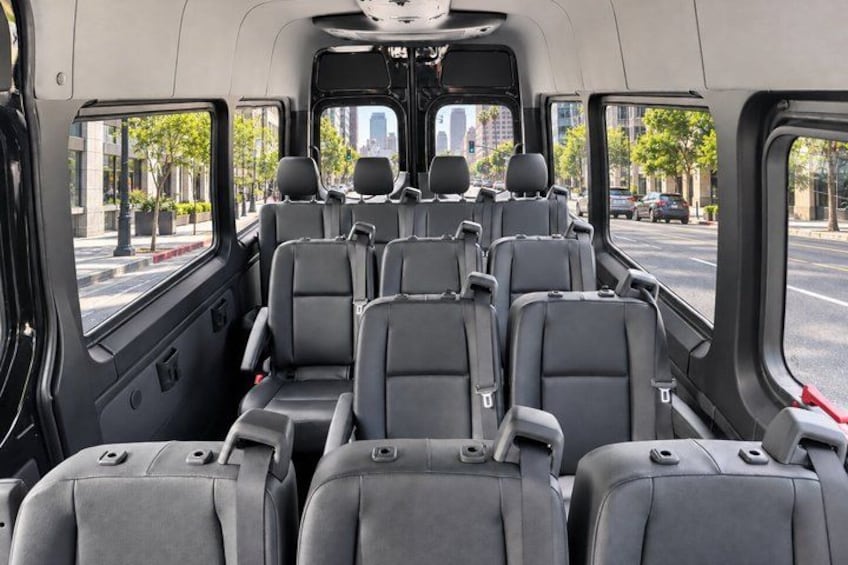 A bus interior with multiple rows of seats and windows. 2
