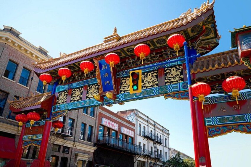 A traditional Chinese gate with red lanterns and intricate golden decorations. 1
