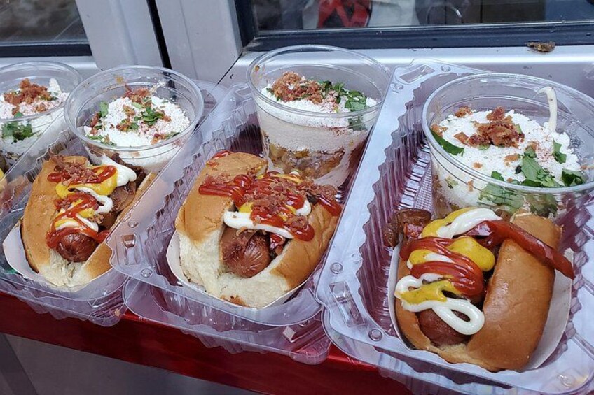 A food display with hot dogs and various toppings. 3