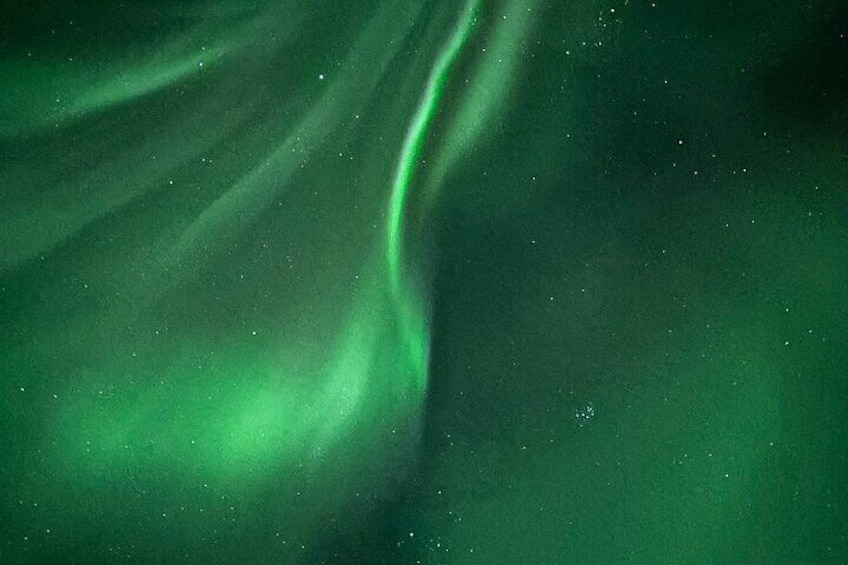 The aurora borealis with green hues and visible light patterns. 3