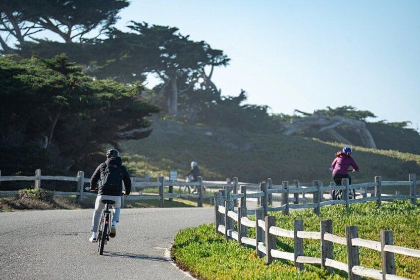 iders cruising past Cypress Point Golf Club on the scenic 17 Mile Drive eBike Tour through Pebble Beach. 1