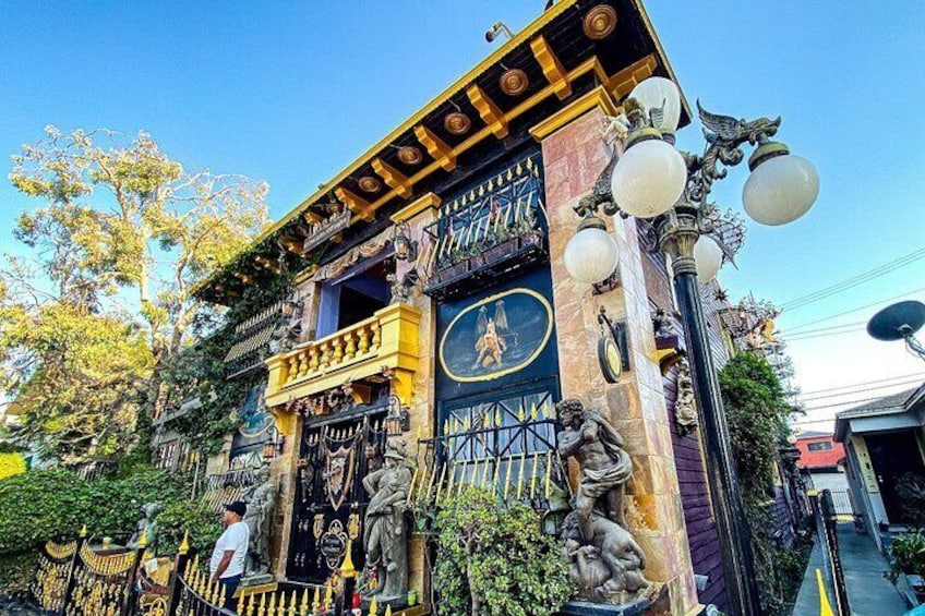 A building with ornate architecture, including statues and a balcony. 2