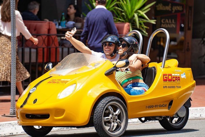 A yellow GoCar on a city street with a GPS-guided tour. 3