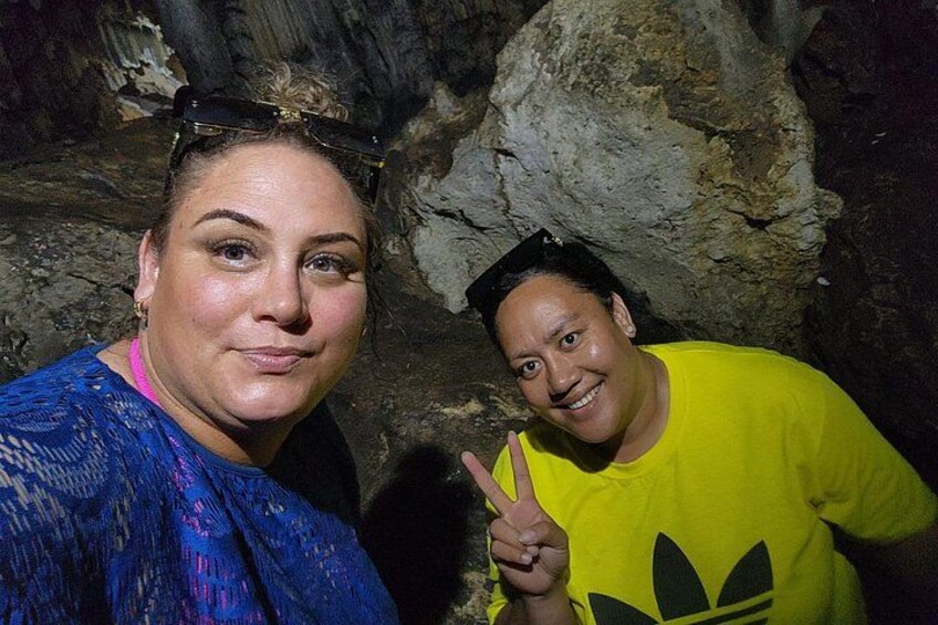 Two people in a cave with rocky walls. 3