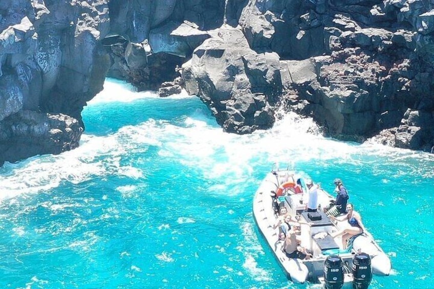 A boat navigating through a narrow, rocky waterway surrounded by cliffs. 5