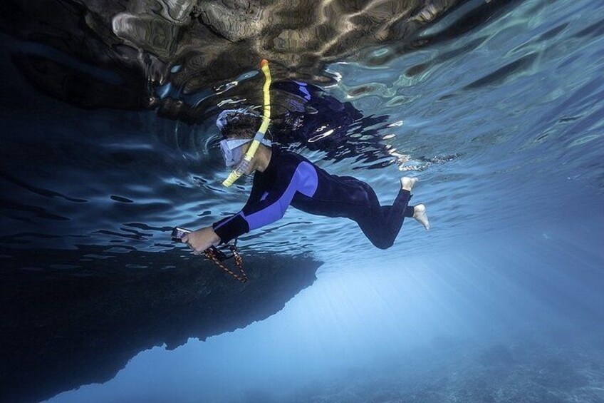 A person scuba diving underwater. 3