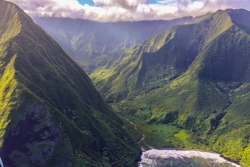 A valley with steep mountains and a river. 3