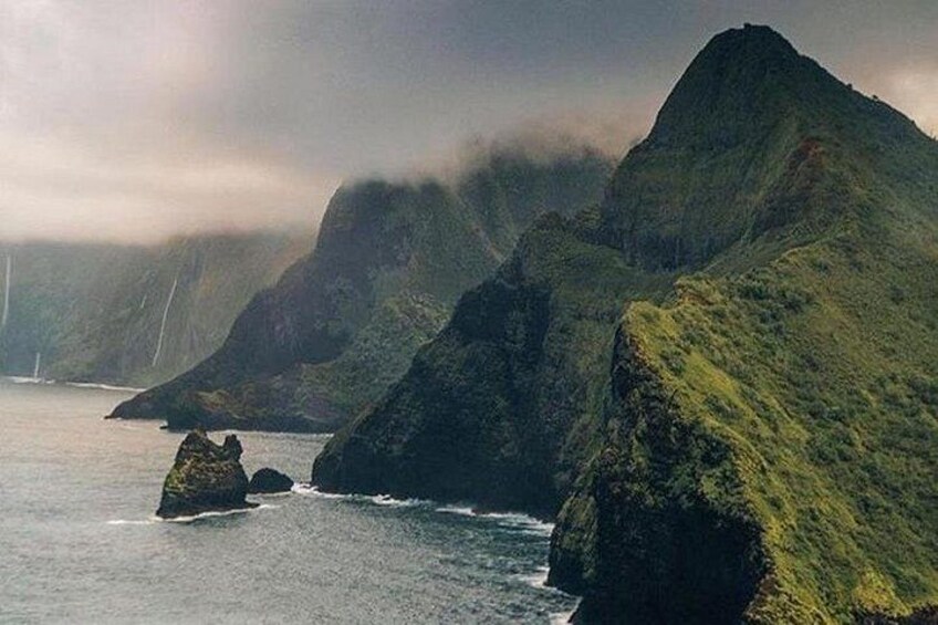 A coastal landscape with rocky cliffs and a body of water. 2
