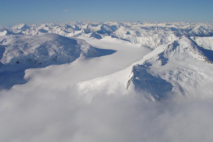 A snow-covered mountain range with a glacier and a valley. 2