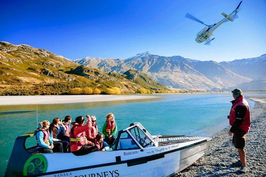 A boat with passengers, a helicopter, and a mountainous landscape. 5