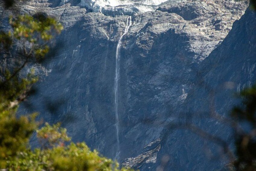 A waterfall cascading down a steep, rocky cliff. 3
