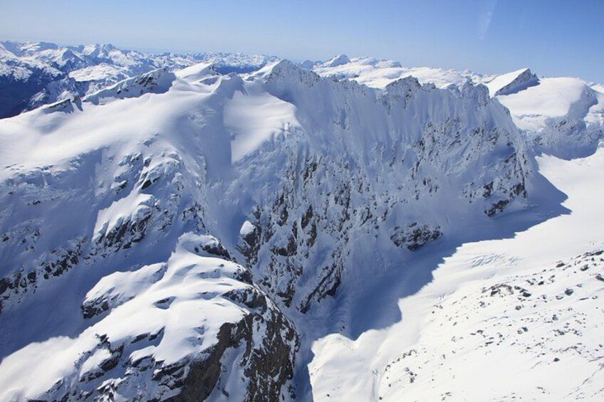 A snow-covered mountain range with sharp peaks and ridges. 2