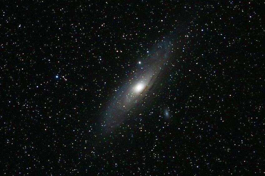 A galaxy with a bright core and faint spiral arms. 4