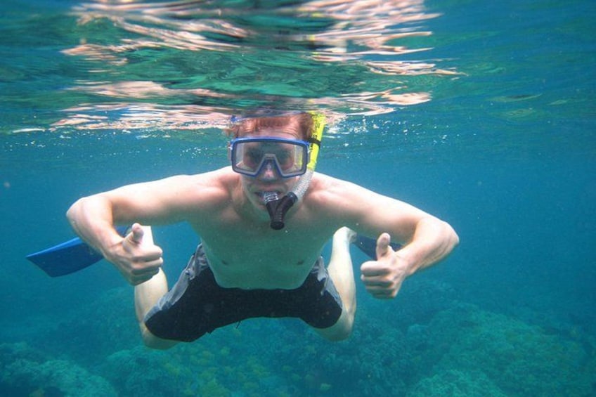 A person underwater with fins, giving a thumbs-up. 5