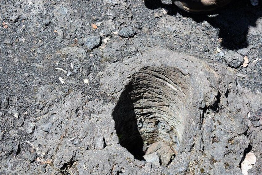 A volcanic crater with a circular shape and a rough, uneven surface. 2