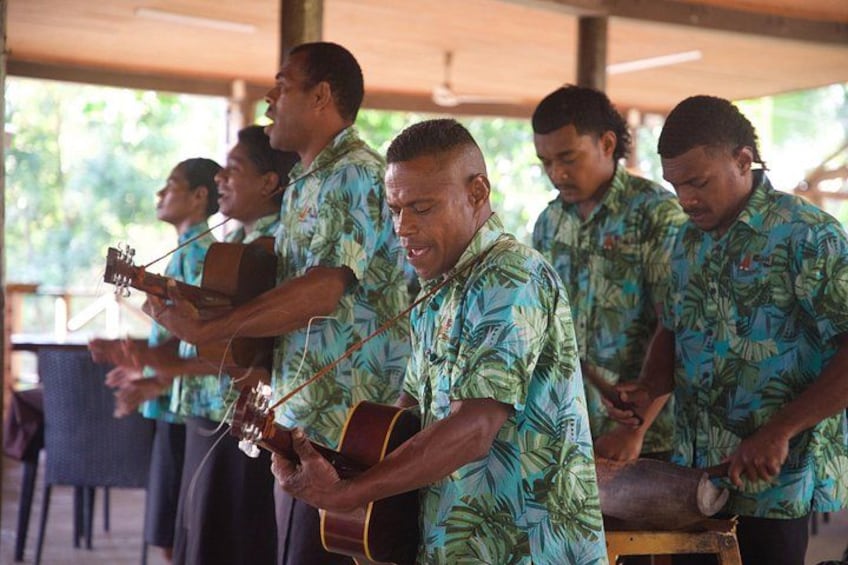 A group of people in tropical shirts playing guitars. 2